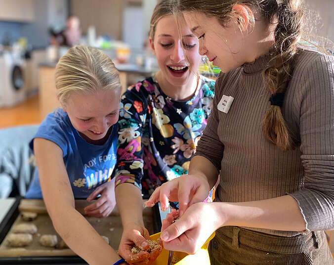 Drei Mädchen kochen.