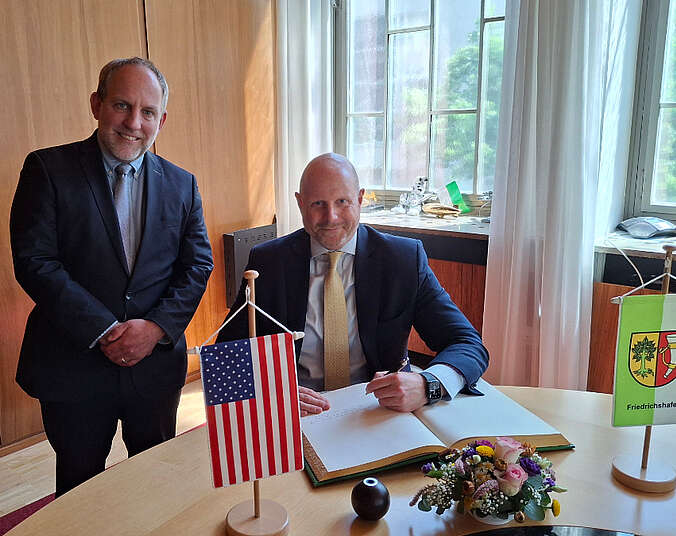 Mann schreibt in Buch.(Foto: Stadt Friedrichshafen)