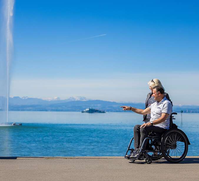 Rollstuhlfahrer schaut über den See
