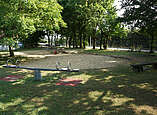 Spielplatz mit Wippe und Sandkasten.